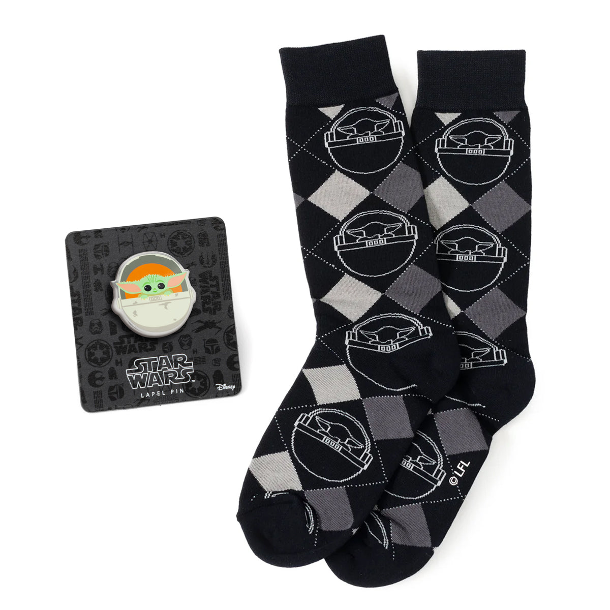 Embrace the charm of the galaxy's favorite foundling with the Grogu Argyle Charcoal Gift Set. This delightful set includes a pair of charcoal argyle socks featuring an adorable image of Grogu and a matching lapel pin. Perfect for the Star Wars fan who adores "The Mandalorian," these accessories blend classic style with whimsical appeal. Showcase your love for Grogu with every step and detail. Image 1